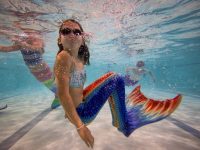 BOURNEMOUTH, ENGLAND - AUGUST 19: Mermaiding students swim in their tails during a Mayim Mermaid Academy lesson at the swimming pool at Bournemouth Collegiate School on August 19, 2017 in Bournemouth, England. The ancient Assyrian goddess Atargatis is thought to be one of the earliest mermaids and like Ea, the Babylonian god of the sea from around 4000bc, she had the upper body of a human and the lower body of a fish. Throughout history Merfolk have been popular in art and literature. A well known Hans Christian Anderson fairy tale "The Little Mermaid" (1836) was adapted to an animated film in 1990 and is still popular today. Recently the practice of mermaiding has become popular across the world as an extreme sport and cosplay/performance art. Mermaiding involves the wearing of a costume mermaid tail, consisting of a plastic monofin covered in a fabric, while swimming or performing. The practice of mermaiding has been taught by professional instructors in the UK since 2006. (Photo by Jack Taylor/Getty Images)