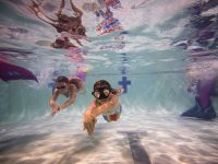 BOURNEMOUTH, ENGLAND - AUGUST 19: Mermaiding students swim in their tails during a Mayim Mermaid Academy lesson at the swimming pool at Bournemouth Collegiate School on August 19, 2017 in Bournemouth, England. The ancient Assyrian goddess Atargatis is thought to be one of the earliest mermaids and like Ea, the Babylonian god of the sea from around 4000bc, she had the upper body of a human and the lower body of a fish. Throughout history Merfolk have been popular in art and literature. A well known Hans Christian Anderson fairy tale "The Little Mermaid" (1836) was adapted to an animated film in 1990 and is still popular today. Recently the practice of mermaiding has become popular across the world as an extreme sport and cosplay/performance art. Mermaiding involves the wearing of a costume mermaid tail, consisting of a plastic monofin covered in a fabric, while swimming or performing. The practice of mermaiding has been taught by professional instructors in the UK since 2006. (Photo by Jack Taylor/Getty Images)